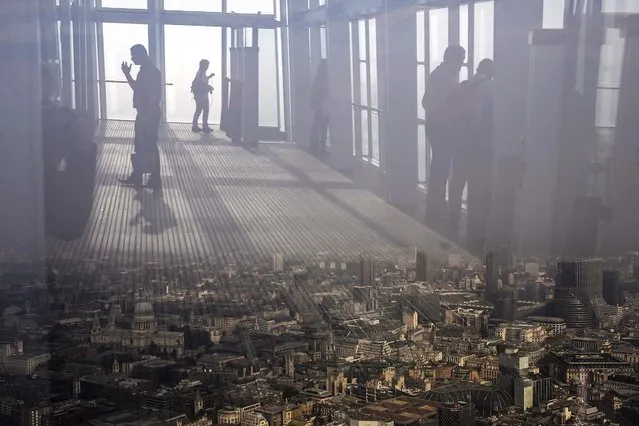 People admire the view from the 72nd floor of the Shard on a foggy day on September 18, 2014 in London, England. The Shard, at 310m is the tallest building in Western Europe with public viewing decks on the 68th, 69th and 72nd floors. (Photo by Dan Kitwood/Getty Images)