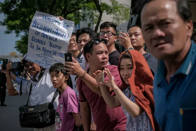 Vietnamese cheer as the convoy transporting President Donald Trump passes by on Nguyen Van Linh Road on November 10, 2017 in Danang, Vietnam. (Photo by Linh Pham/Getty Images)