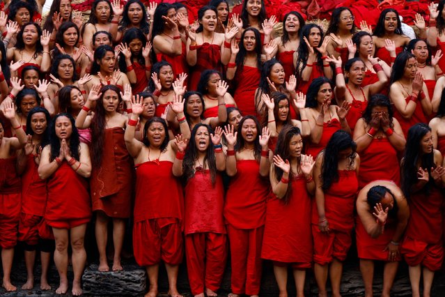 Nepalese women stand on the banks of the Bagmati river to take a holy bath during the month-long Swasthani Bratakatha festival, dedicated to Goddess Swasthani and Lord Madhav Narayan, at Pashupatinath Temple in Kathmandu, Nepal, on Monday, January 29, 2025. (Photo by Skanda Gautam/ZUMA Press Wire/Alamy Live News)