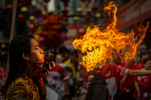 A performer breathes fire during Lunar New Year celebrations at Binondo district, considered the world's oldest Chinatown, on January 29, 2025 in Manila, Philippines. Chinese New Year, also known as Lunar New Year, will begin on January 29, 2025, marking the Year of the Snake. The celebrations, which last for approximately 15 days, are filled with traditional activities such as family gatherings, lion dances, and the exchange of red envelopes, making it a vibrant cultural event observed by Chinese communities worldwide. (Photo by Ezra Acayan/Getty Images)