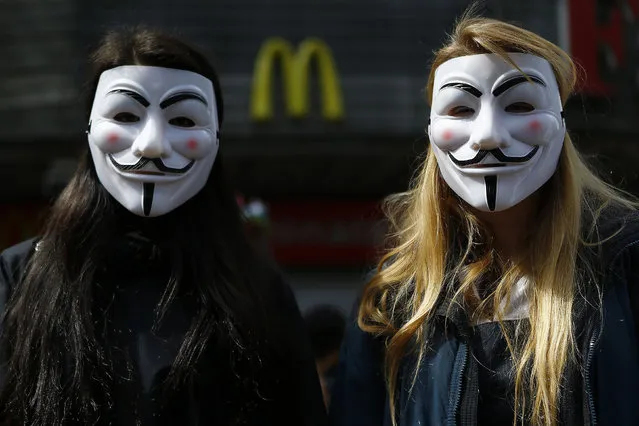 Students wearing Guy Fawkes masks take part in a demonstration against the government to demand changes and an end to profiteering in the education system in Santiago October 9, 2014. (Photo by Ivan Alvarado/Reuters)