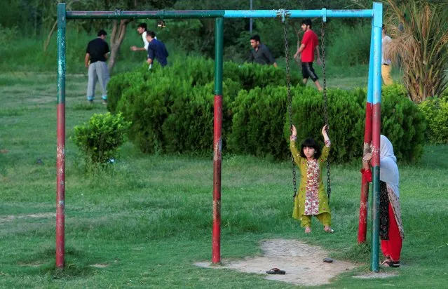 A girl rides on a swing at a park in Islamabad, Pakistan July 29, 2016. (Photo by Faisal Mahmood/Reuters)