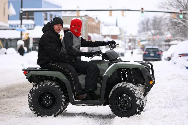 Residents travel by four-wheeler during a snowstorm as extreme winter weather hits Buffalo, New York, U.S., November 18, 2022. (Photo by Lindsay DeDario/Reuters)