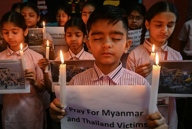 School children holding candles pray for earthquake victims in Myanmar and Thailand, in Amritsar on March 29, 2025. The death toll from a huge earthquake that hit Myanmar and Thailand passed 1,000 on March 29, as rescuers dug through the rubble of collapsed buildings in a desperate search for survivors. (Photo by Narinder Nanu/AFP Photo)