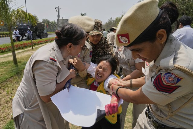 Policewomen detain an exile Tibetan protesting against the death of Tulku Hungkar Dorje, a revered Tibetan religious leader, while in custody in Vietnam, outside Chinese embassy in New Delhi, India, Friday, April 11, 2025. (Photo by Manish Swarup/AP Photo)