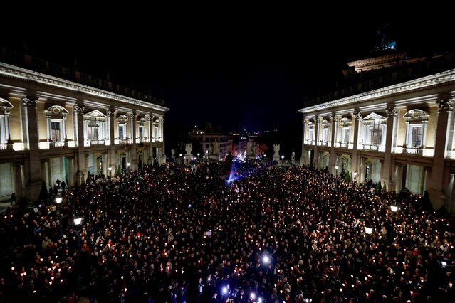 People hold candles as they attend a vigil in memory of late Russian opposition leader Alexei Navalny, at the Campidoglio (Capitoline Hill) in Rome, Italy, on February 19, 2024. (Photo by Yara Nardi/Reuters)
