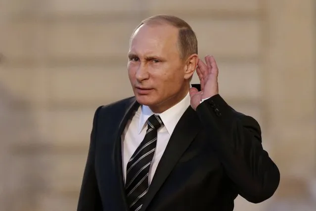 Russian President Vladimir Putin cups his ear to listen to a question as he departs after a summit on the Ukraine crisis at the Elysee Palace in Paris, France, October 2, 2015. France hosted a meeting with leaders of Russia, Germany and Ukraine in Paris for talks about Ukraine which were likely to be overshadowed by the conflict in Syria. (Photo by Philippe Wojazer/Reuters)
