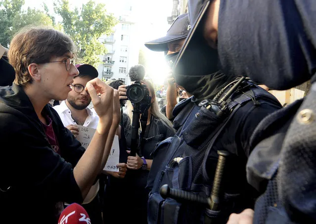 Activist Malgorzata Szutowicz, left, known as Margot, confronts police before being arrested in Warsaw, Poland, on Friday August 7, 2020. LGBT rights activists scuffled with police Friday in Warsaw after turning out on the streets to protest the arrest of an an activist. According to Polish media reports, the activist was placed under two-months arrest Friday for protest actions against anti-homosexual attitudes. After the person was arrested in central Warsaw, protesters surrounded the police car and one person climbed on top of it. (Photo by Czarek Sokolowski/AP Photo)