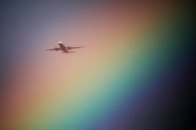 A British Airways airplane flies near a rainbow on its way to Heathrow Airport in London, Britain, July 23, 2017. (Photo by Kevin Coombs/Reuters)