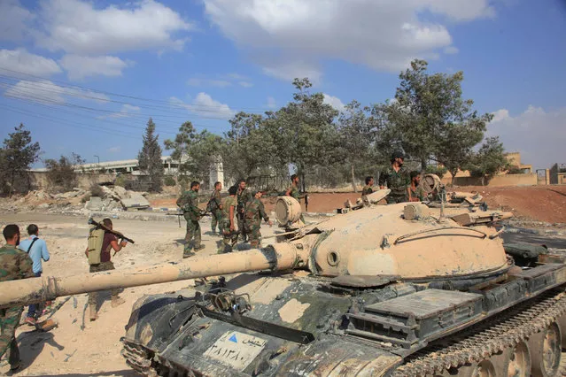 Forces loyal to Syria's President Bashar al-Assad walk past a tank at a military complex, after they recaptured areas in southwestern Aleppo on Sunday that rebels had seized last month, Syria, in this handout picture provided by SANA on September 5, 2016. (Photo by Reuters/SANA)