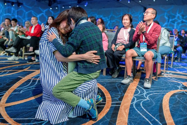 Zachary Ji-Hsien Teoh, 8, of Houston, Texas hugs his mother Joanne Yeap after he was eliminated during the quarterfinals of the annual Scripps National Spelling Bee in National Harbor, Maryland on May 28, 2025. (Photo by Nathan Howard/Reuters)