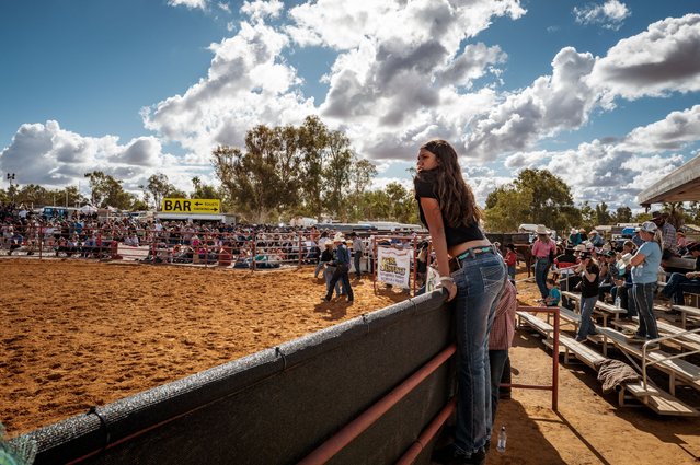 A person stands on the fence looking in to the Arena on May 31, 2025 in Mullewa, Australia. The annual Mullewa Muster & Rodeo in Western Australia's Mid West region showcases traditional rodeo events including bull riding, saddle bronc, and barrel racing. Crowds gather at the Mullewa Recreation Grounds for a day of action-packed competition and country entertainment. The rodeo is a highlight on the regional calendar, celebrating local agricultural heritage and rural community spirit. (Photo by Tamati Smith/Getty Images)