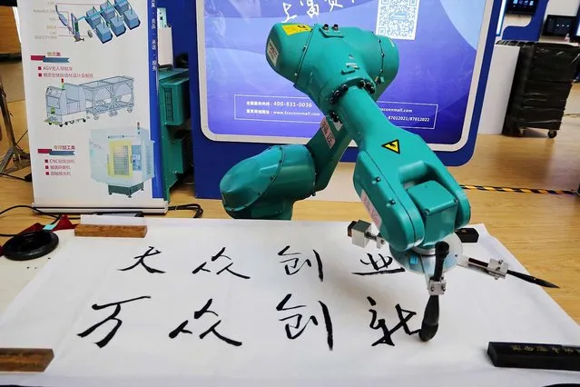 A robot named “Fu Jiang” writes traditional Chinese calligraphy at an expo center in Zhengzhou, the capital of central China's Henan Province on September 20, 2016. It costs more than 200,000 yuan ($30,000). (Photo by Wang Wei/ZUMA Press/Splash News)