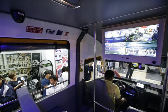 In this October 12, 2017, photo, a man checks a prototype of the modern Public Utility Vehicle (PUV) that is equipped with public Wi-Fi and on-board camera during an exhibit in Manila, Philippines. (Photo by Aaron Favila/AP Photo)