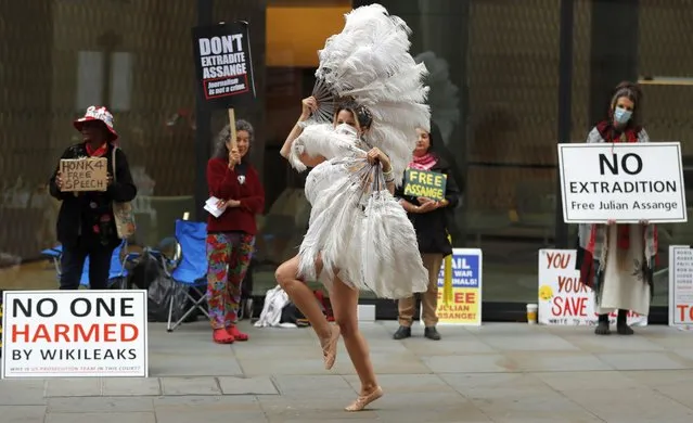 A dancer performs in protest opposite the Central Criminal Court, the Old Bailey, in London, Monday, September 21, 2020, as the Julian Assange extradition hearing to the US continues. (Photo by Frank Augstein/AP Photo)