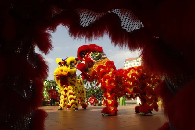 In this Monday, February 12, 2018, file photo, a traditional lion dance team performs ahead of the Lunar New Year in Phnom Penh, Cambodia. (Photo by Heng Sinith/AP Photo)