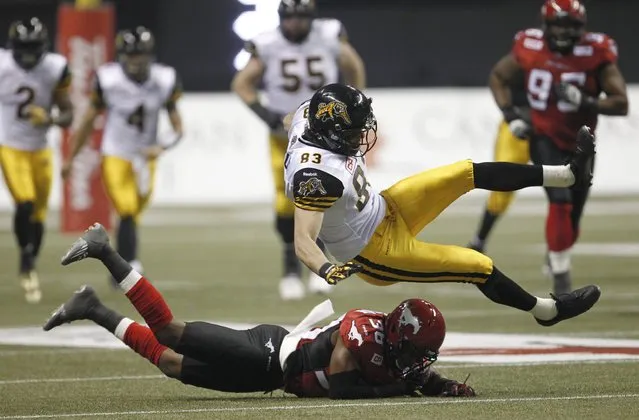 Calgary Stampeders' Buddy Jackson (38) tackles Hamilton Tiger Cats' Andy Fantuz in the first half during the CFL's 102nd Grey Cup football championship in Vancouver, British Columbia, November 30, 2014. (Photo by Andy Clark/Reuters)