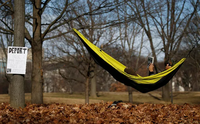 Marcus Gruley lays in a hammock in a park adjacent the Lincoln Memorial reflecting pool during the Second Annual Women's March in Washington, U.S., January 20, 2018. (Photo by Leah Millis/Reuters)