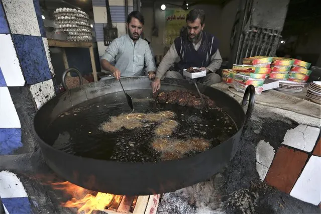 A vendor prepares “Chapli kababs” for a customers at a traditional restaurant in Peshawar, Pakistan, Wednesday, February 1, 2023. (Phoot by Muhammad Sajjad/AP Photo)