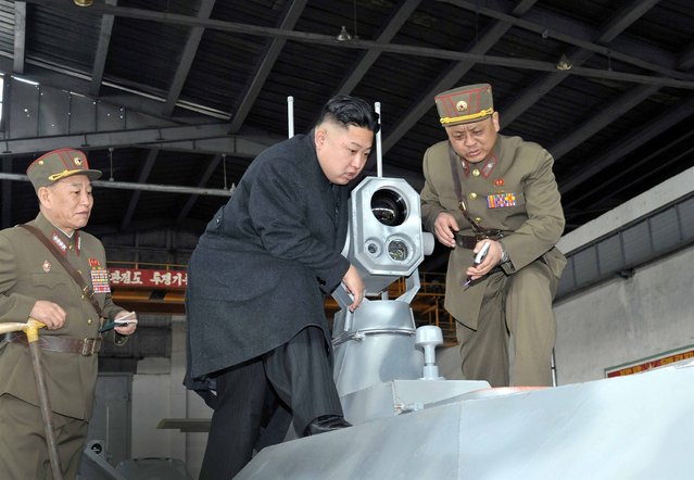 Kim Jong Un looks at the latest combat and technical equipment, made by unit 1501 of the Korean People's Army, during his visit to the unit on March 24, 2013. (Photo by Reuters/KCNA)