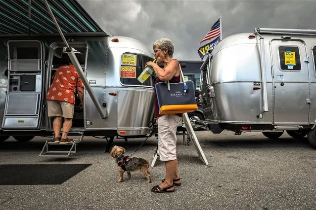 Visitors view recreational vehicles (RV), mobile homes, and motor homes during the West Palm Beach RV Show at the South Florida Fairgrounds in West Palm Beach, Florida, on February 19, 2023. (Photo by Giorgio Viera/AFP Photo)