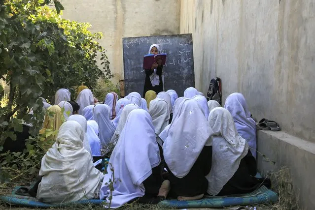 Afghan students attend an open air class at a primary school in Kabul, Afghanistan, Wednesday, October 7, 2020. The World Bank said this week that nearly half of Afghanistan’s 18,000 schools lack proper buildings and an estimated 3.7 million children are still out of school — despite massive investment in the country’s education sector. (Photo by Mariam Zuhaib/AP Photo)