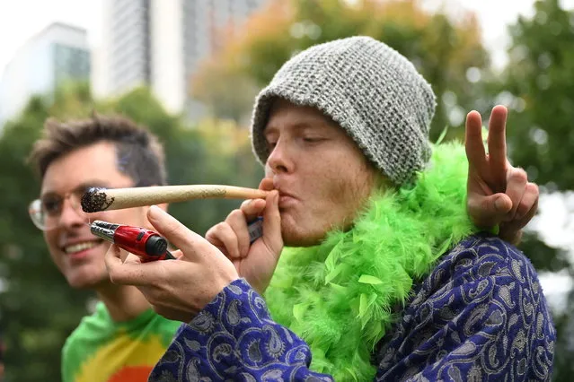 A man is seen lighting a joint at a 420 Rally and Community Picnic 2023 in Melbourne, Australia, 20 April 2023. The annual '420 or 4/20' is known in cannabis culture as Cannabis Day or Weed Day and has become an international counterculture holiday based on the celebration and consumption of cannabis with events advocating for cannabis legalisation. (Photo by James Ross/EPA)