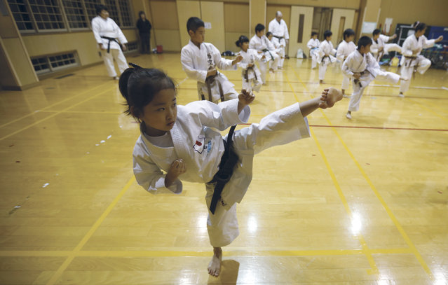 In this November 18, 2015 photo, 9-year-old Mahiro Takano, center, three-time Japan karate champion in her age group practices in Nagaoka, Niigata Prefecture, north of Tokyo. (Photo by Eugene Hoshiko/AP Photo)