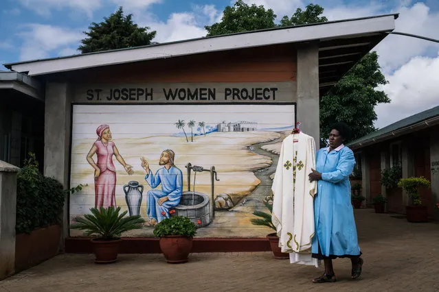 A parishioner of the St. Joseph the Worker Parish in Nairobi's Kangemi slum carries the vestments to be worn by Pope Francis during his visit to Kenya on November 24, 2015 in Kenya. Pope Francis makes his first visit to Kenya on a five day African tour that is scheduled to include Uganda and the Central African Republic. Africa is recognised as being crucial to the future of the Catholic Church with the continent's Catholic numbers growing faster than anywhere else in the world. (Photo by Nichole Sobecki/Getty Images)