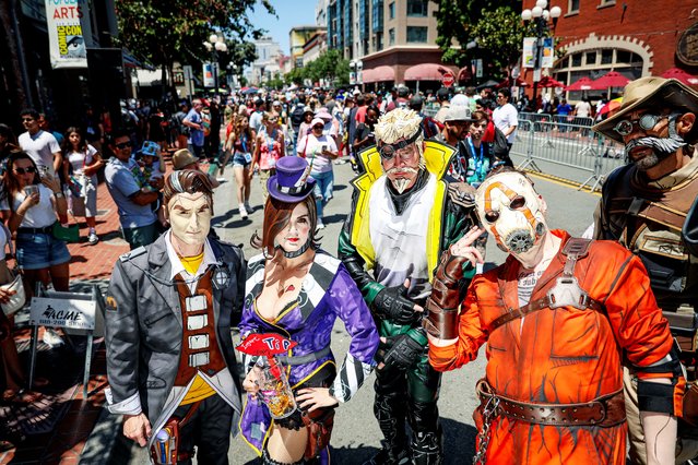 Cosplayers walk along 5th Avenue in the Gaslamp Quarter during Comic-Con International in San Diego, California on July 27, 2024. (Photo by Sandy Huffaker/Reuters)