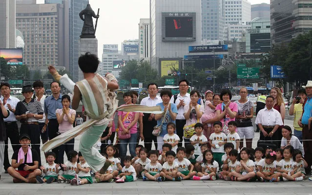 A South Korean Taekwondo expert performs martial arts during an event for tourists in Seoul, South Korea, Wednesday, June 26, 2013. (Photo by Ahn Young-joon/AP Photo)