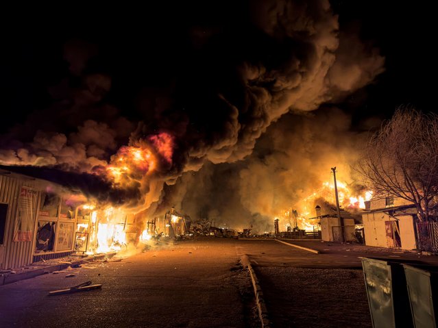 A local market burns after a Russian strike in Mykolaiv, Ukraine, on Tuesday, October 15, 2024. Ukraine is facing setbacks on its eastern frontline, with Russia claiming incremental advancements in the Donetsk region and continuing to attack Ukrainian cities with drone and missile strikes. (Photo by Marko Ivkov/AP Photo)