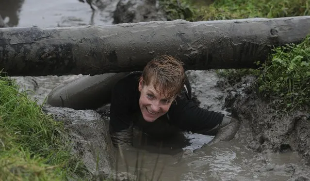 A competitor takes part in the Christmas Really Wild Mud Run on a 4.6 miles course across undulating farm land at Celtic Camping, St David's, Pembrokeshire, Wales, December 12, 2015. (Photo by Rebecca Naden/Reuters)