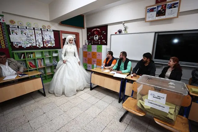 23 year-old Ozge Coban and 24 year-old Ismail Coban couple arrives at a polling station, with a wedding dress and a groom before their wedding ceremony, to cast their votes during the second round of Turkiye's presidential elections in Duzce, Turkiye on May 28, 2023. Millions of voters started heading to the polls in Turkiye as the country's second round of presidential elections began Sunday at 8 a.m. local time (0500GMT). (Photo by Omer Urer/Anadolu Agency via Getty Images)