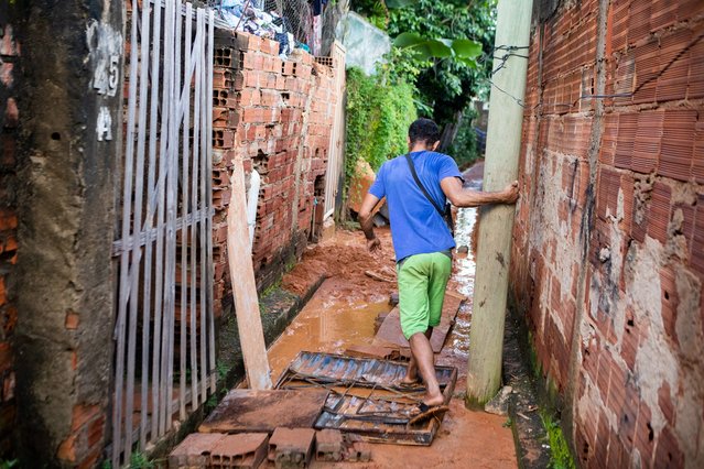 A man walks on a street covered in mud after a landslide at Bethania neighborhood, Ipatinga, Minas Gerais state, Brazil on January 12, 2025. Landslides caused by torrential rains in southeast Brazil have left at least seven people dead and four others missing, rescue services in Minas Gerais state said January 12. (Photo by Nilmar Lage/AFP Photo)