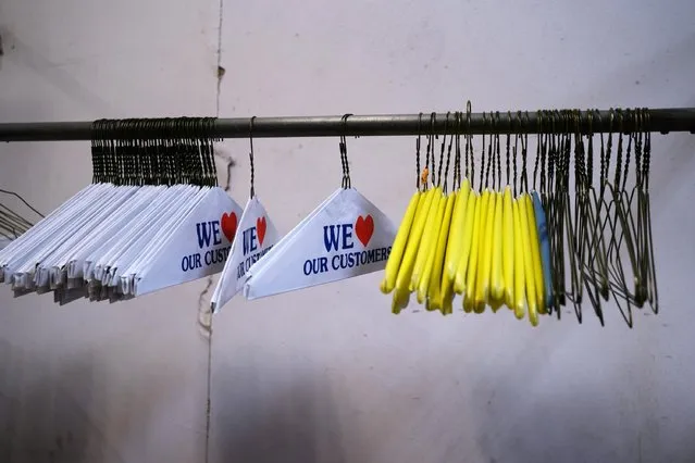 Empty hangers hang at a dry cleaners, as businesses struggle with continued work from home protocols to limit the spread of the coronavirus disease (COVID-19), in Philadelphia, Pennsylvania, U.S., March 2, 2021. (Photo by Caroline Gutman/Reuters)