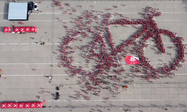 Local residents leave after making a formation in the shape of a bicycle in an attempt to do the world's largest bicycle as part of a Bicycle Festival, in Santiago, Chile on May 27, 2023. (Photo by Ivan Alvarado/Reuters)