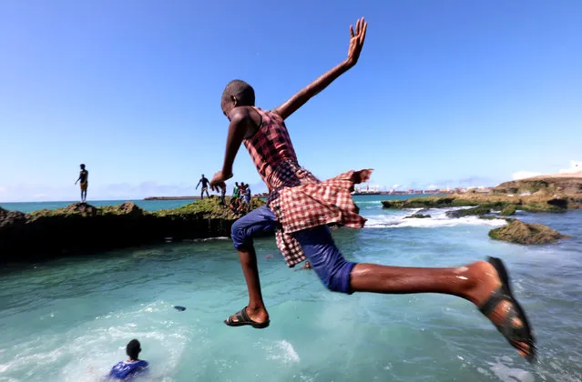 A boy jumps into the Indian Ocean at the Xamarweyne beach in Mogadishu, Somalia on September 14, 2018. (Photo by Feisal Omar/Reuters)