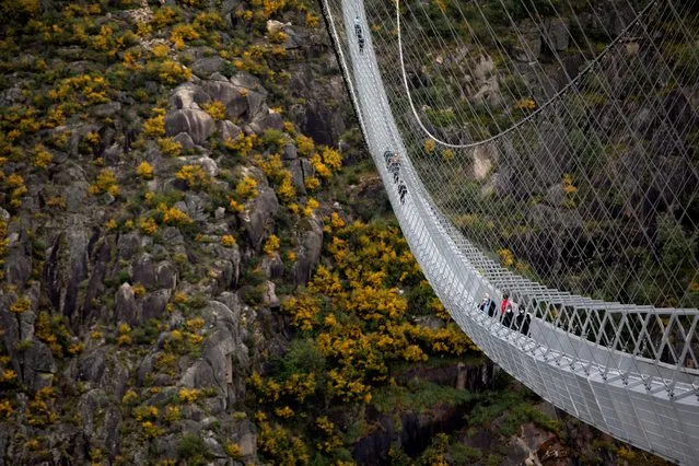 People walk on the world's longest pedestrian suspension bridge “516 Arouca”, now open for local residents in Arouca, Portugal, April 29, 2021. (Photo by Violeta Santos Moura/Reuters)