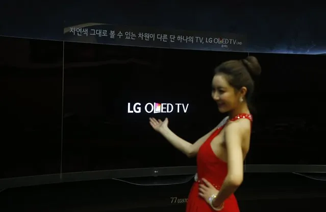 A model poses for photographs with LG Electronics Inc's Super Ultra HD Television sets during its launch event at company's headquarters in Seoul February 24, 2015. (Photo by Kim Hong-Ji/Reuters)