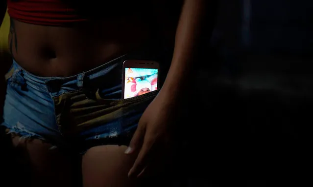 Venezuelan s*x worker Alejandra, 37, with her mobile phone in her pocket, remains at a bar in Calamar municipality, Guaviare department, Colombia on October 11, 2018. Venezuelan migrants who fled their country due to the crisis, turn to prostitution in Colombia for the lack of opportunities to work in other trades. (Photo by Raúl Arboleda/AFP Photo)