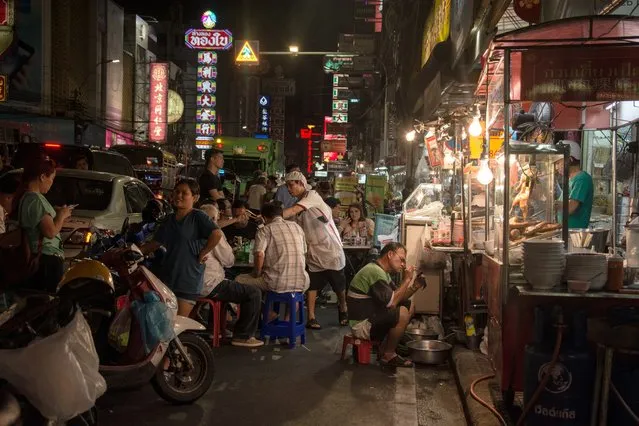 “Evening chaos in Bangkok’s Chinatown, where food vendors fill the pavements and customers compete with traffic for road space. The food is worth risking your life for!”. (Photo by Chloe Beale/Guardian Witness)
