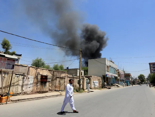 Smoke rises from an area where explosions and gunshots were heard, in Jalalabad city, Afghanistan July 31, 2018. (Photo by Reuters/Parwiz)