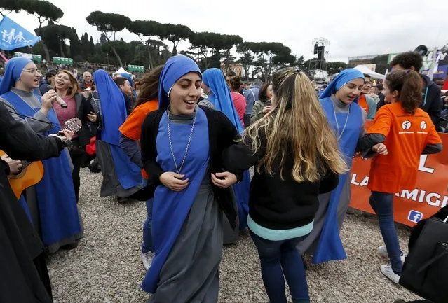 Nuns dance during a rally against same-s*x unions and gay adoption in Rome, Italy January 30, 2016. Tens of thousands of Italians staged a mass rally in Rome's Circus Maximus on Saturday to urge the government to drop legislation that offers homosexual couples legal recognition and limited adoption rights. (Photo by Remo Casilli/Reuters)