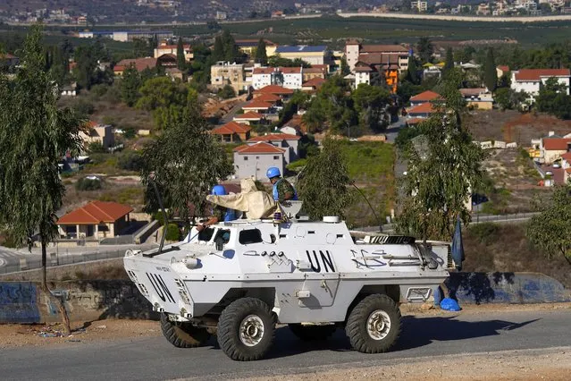 U.N. peacekeepers patrol on the Lebanese side of the Lebanon-Israel border in the southern village of Kfar Kila, with the Israeli town of Metula in the background, Lebanon, Friday, October 13, 2023. (Photo by Bilal Hussein/AP Photo)