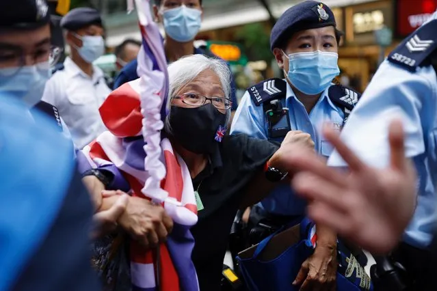 A pro-democracy protester with a Union flag mask is taken by police at Causeway Bay after police denied permission for a protest rally during the 24th anniversary of the former British colony’s return to Chinese rule, on the 100th founding anniversary of the Communist Party of China, in Hong Kong, China on July 1, 2021. (Photo by Tyrone Siu/Reuters)