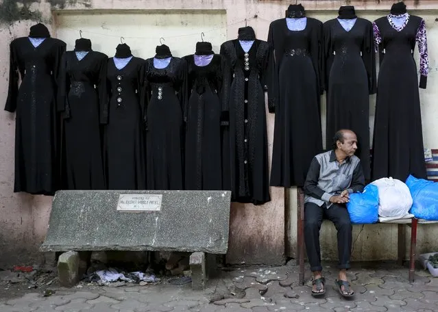 A vendor waits for customers as burqas on sale are displayed on a wall at a market in Mumbai, India, in this September 8, 2015 file photo. (Photo by Danish Siddiqui/Reuters)