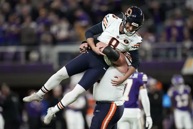 Chicago Bears place-kicker Cairo Santos (8) celebrates with teammate guard Lucas Patrick after kicking a 30-yard field goal during the second half of an NFL football game against the Minnesota Vikings, Monday, November 27, 2023, in Minneapolis. The Bears won 12-10. (Photo by Abbie Parr/AP Photo)