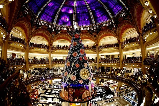 A giant Christmas tree stands in the middle of the Galeries Lafayette department store in Paris. (Photo by Charles Platiau/Reuters)