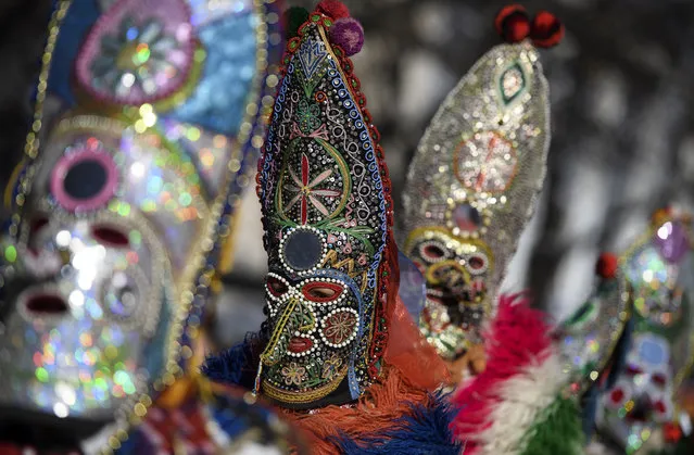 Mask dancers take part in a parade during the the International Festival of Masquerade Games “Surva” in the town of Pernik, some 30 km from Sofia, Bulgaria, 27 January 2019. In ancient times the old Thracians held the Kukeri Ritual Games in honor of god Dionysus – known as a god of wine and ecstasy. Even today these games are also known as the Dionysus' games. Among the Kukeri dancers' are many characters, including Dionysus and his satyrs as well as others from deep history such as the tsar, harachari, plyuvkachi, startzi, and pesyatzi. (Photo by Vassil Donev/EPA/EFE)